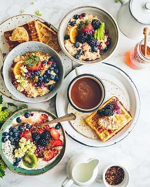 Spring Easter brunch with waffles, fresh berries, porridge and coffee at Sunstar Hotel Pontresina.